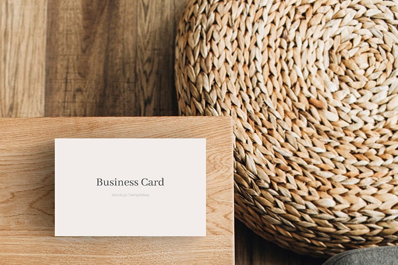 Photoshop Business Card Mockup on Wooden Backdrop and Rattan Podium