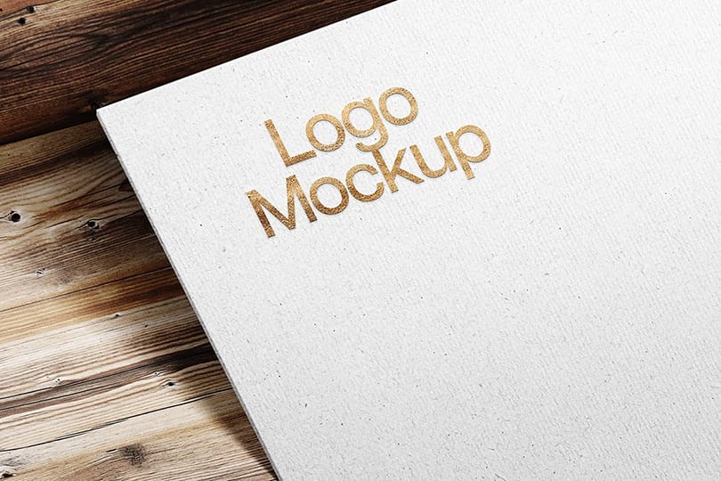 Photoshop Gold Paper Logo Mockup with Realistic Shadow on Wood Texture