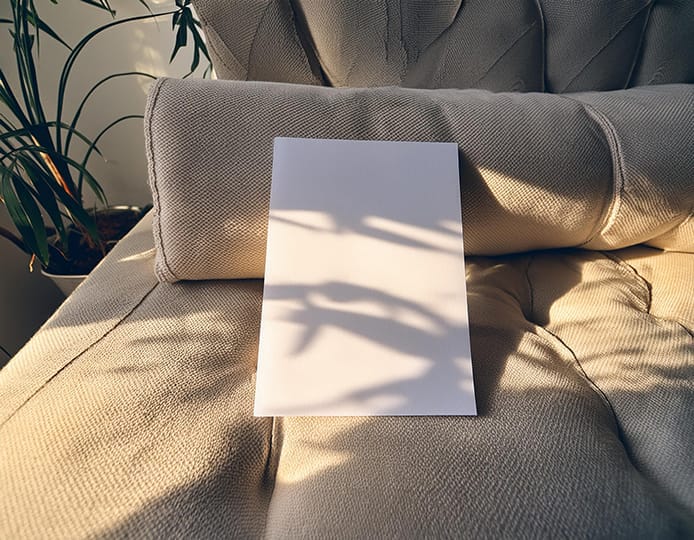 Image A4 Paper Mockup Laid On Sofa