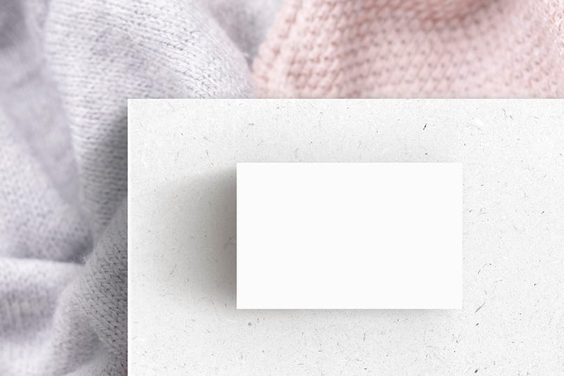 Image Business Card On White Paper & Knitted Fabric Mockup