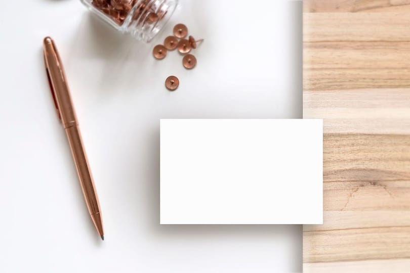 Image Business Card on White Wooden Surface Pins Pen Mockup