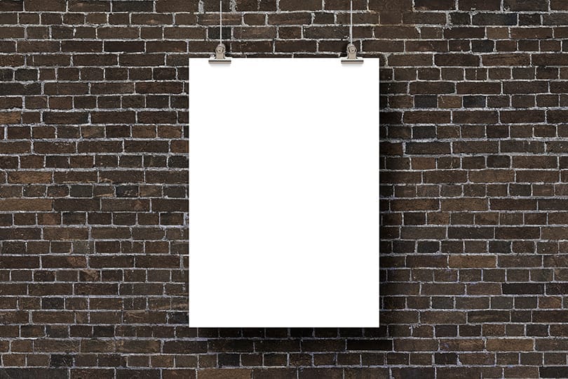 Image Hanging Poster Mockup on Brick Backdrop