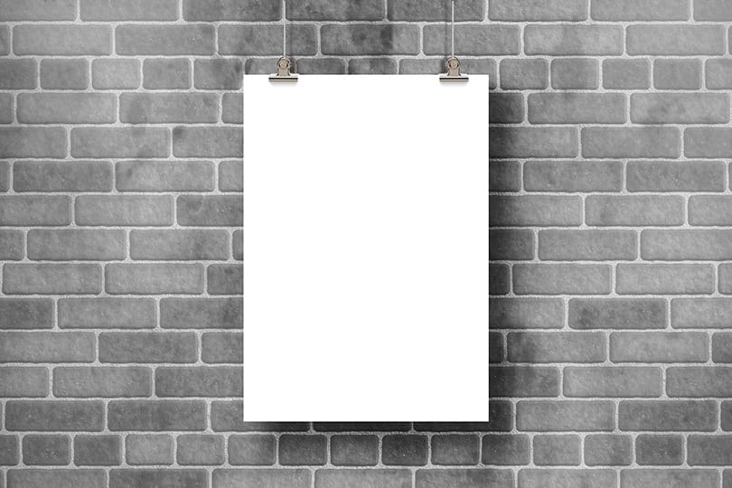 Image Hanging Poster Mockup on Brick Surface Background