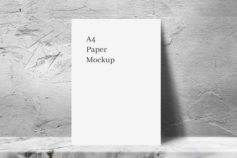 Photoshop A4 White Paper Mockup with Rough Cement Wall Texture