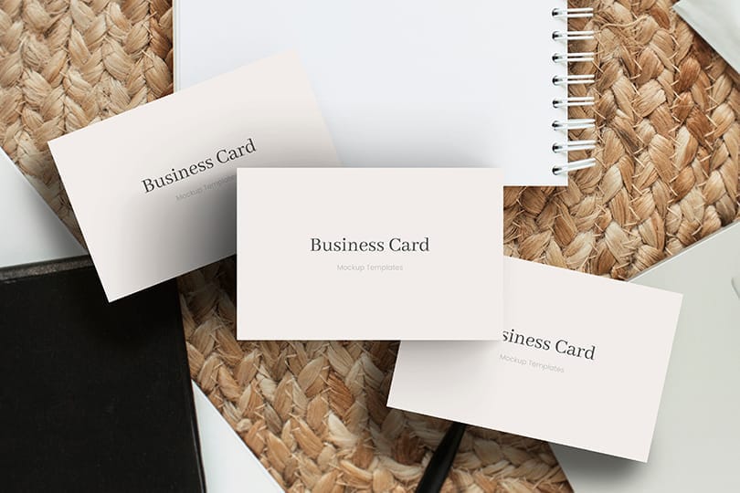 Three Business Card Mockup  With Notebook and Rattan Background