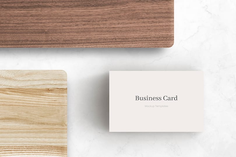 White Business Card Mockup Between Two Wood Plate