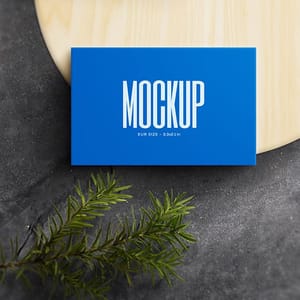 Photoshop Blue Business Card Mockup on Wood Plate with Plant Object