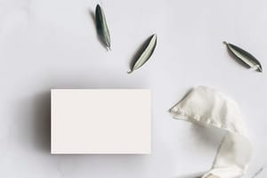 Image Business Card On White Texture Paper With Leaf & Fabric Mockup