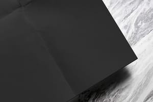 Image Folded Black Scan Mockup on Classic Marble