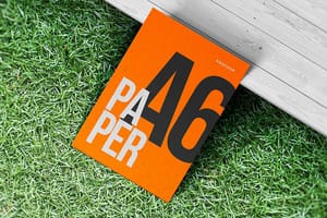 Photoshop Orange A6 Paper Mockup on Grass Ground